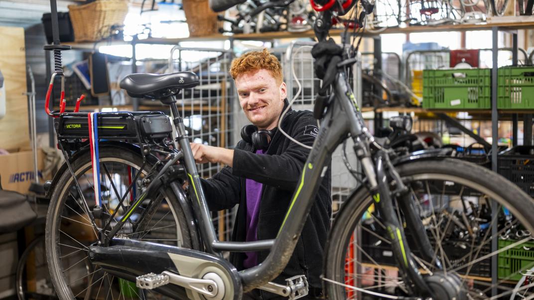 Persoon repareert een fiets.